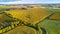 Farmland Corn harvest. September agriculture fields aerial panorama. Sunny autumn landscape