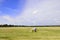 Farmland and hay bales and green pastures white wrap