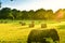 Farmland meadow with straw bale at sunset. French Brittany