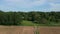 Farmland road and freshly sowed cultivated fields in spring, aerial