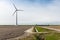 Farmland with a wind turbine of the biggest windfarm in the Netherlands