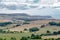 Farmlands and trees by the sea panorama, distant view of land by the ocean in United Kingdom, cloudy sea and green