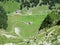 Farms and pastures on tableland mountain ranges Alpstein