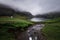 Faroe islands - Grass roof houses in the small village Saksun, Dark clouds atmosphere