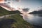 Faroe Islands Kalsoy in sunset light durig twilight with pink sky and cliffs.