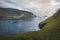 Faroe Islands Kalsoy in sunset light durig twilight with pink sky and cliffs.