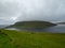 Faroe Islands. Leitisvatn Lake, view from TrÃ¦lanÃ­pan. Field of green gras in the foreground.