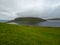 Faroe Islands. Leitisvatn Lake, view from TrÃ¦lanÃ­pan. Field of green gras in the foreground.