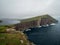 Faroe Islands. TrÃ¦lanÃ­pan. View form Slave Cliffs on the lake Leitisvatn hanging over the ocean.