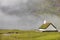 Faroese foggy picturesque landscape with chapel in Saksun. Denmark