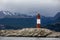 Farol Les Eclaireurs, a red and white striped lighthouse on rocky island on the Beagle Channel, Ushiaia, Argentina