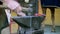 A farrier forging a horseshoe