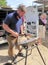 Farrier hammering horseshoe on anvil