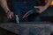 farrier making a traditional horseshoe on a forge