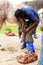 Farrier performing maintenance on old horseshoe for horse hoof