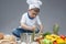 Fascinated Caucasian Little Boy Working With Whisk In Cooking Hat