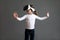 Fascinated female child wearing virtual reality glasses over grey background