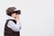 Fascinated little boy using VR virtual reality goggles