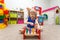 Fascinated little girl playing with wooden hammer in kindergarten