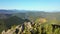 Fascinating aerial footage of a tourist conquering the top of a rocky mountain. Filmed in UHD 4k video