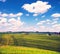 Fascinating beautiful magnetism landscape with tracks of wheels on hills against clouds in Tuscany, Italy. Excellent tourist