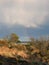 Fascinating blue sky with thunderclouds unloading and a rainbow over Findhorn Bay dunes, Scotland