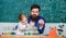 Fascinating chemistry lesson. Man bearded teacher and pupil with test tubes in classroom. Private lesson. School