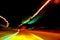 Fascinating mysterious beautiful abstract view of the night highway with lines of lights from cars