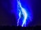 Fascinating mysterious beautiful lightning strike on the dark cloudy sky during a spring storm