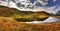 Fascinating scenery of a lake with the reflection of the sky in the middle of a valley