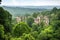 fascinating view of the ruins, with tall trees and rolling hills in the background