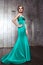 Fashion beauty photo shot of beautiful model in green dress with makeup and hairstyle