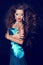 Fashion Beauty Vogue Model Girl in elegant blue dress with blowing wavy hair