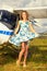 Fashion beautyful woman in pinup style dress nearby ultralight plane