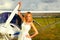 Fashion beautyful woman in white dress nearby ultralight plane