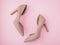Fashion blog look. Pastel glitter golden women high heel shoes on pink background. Flat lay, top view. Minimal feminine