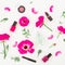 Fashion blogger desk with cosmetics - lipstick, eye shadows, nail polish and pink flowers on white background. Flat lay, top view.