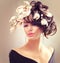 Fashion brunette girl with magnolia flowers hairstyle