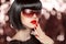 Fashion brunette woman in sunglasses. Black bob hairstyle. Red l