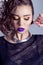 Fashion capture beautiful girl with bright makeup, big full lips with purple lipstick, beautiful hair. Photography makeup