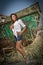 Fashion Caucasian model posing outdoor in front of an old boat