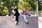 Fashion children girls posing with skate board and penny board on sport ramp on playground. Friends girls chatting