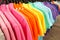 Fashion clothes on clothing rack - bright colorful closet.