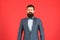 Fashion concept. Businessman or host fashionable outfit red background. Formal outfit. Confident posture. Man bearded