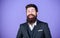 Fashion concept. Impeccable style. Businessman fashionable outfit stand violet background. Man bearded hipster wear