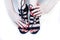 Fashion concept people: woman with red nails manicure pedicure tying shoelaces on hight heel shoes isolated on white