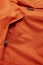 Fashion Concepts. Details Closeup View of Mens Warm Winter Parka Orange Jacket Isolated on White Background