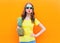 Fashion cool girl in a sunglasses with pineapple over colorful background