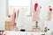 Fashion designer showroom studio workshop background with new collection of pink pastel female clothing design. Tailor and sewing