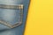 Fashion detail Back pockets of blue jeans on yellow background